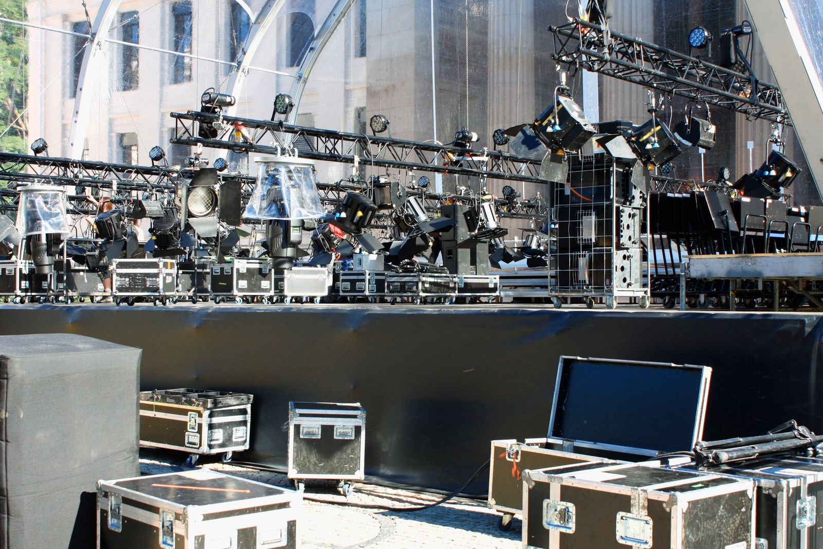 Escenario montado con truss, focos y flightcases al pie
