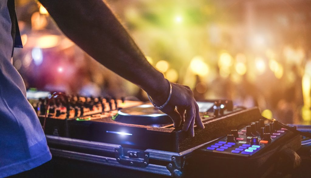 dj mixing outdoor at beach party festival with crowd of people i